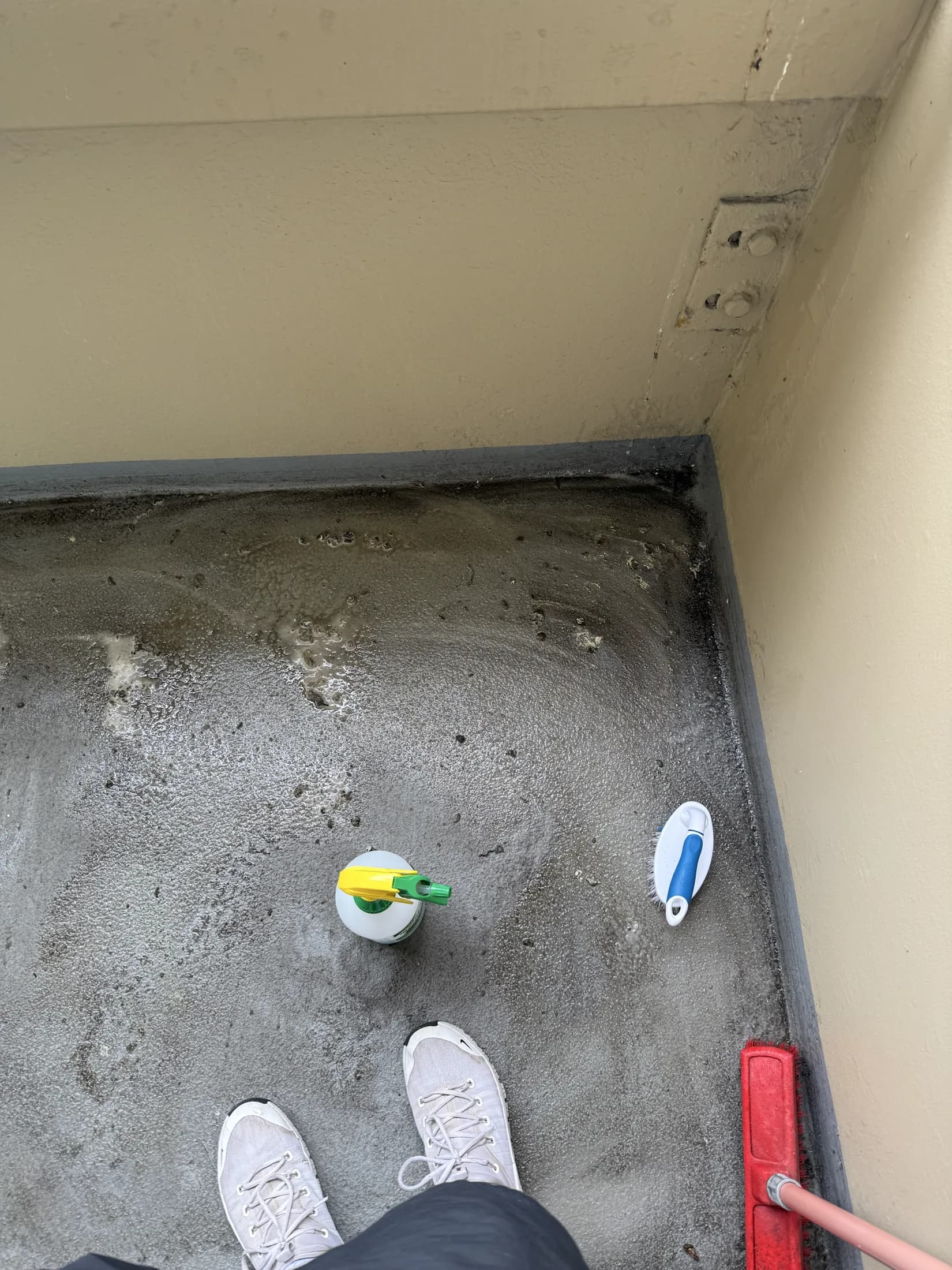 Balcony floor during pigeon-dropping cleanup in Vancouver
